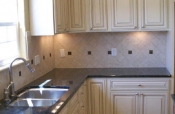 Porcelain kitchen backsplash with pewter inserts