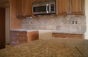Granite countertops with travertine backsplash
