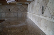 Granite tile countertops with travertine backsplash