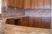Granite countertops with travertine backsplash