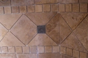 Travertine backsplash with pewter inserts