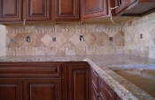 Travertine backsplash with pewter inserts