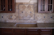 Granite countertops with travertine backsplash