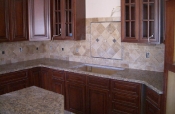 Travertine backsplash with pewter inserts