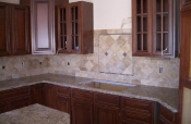 Granite countertops with travertine backsplash
