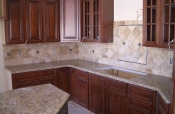Travertine backsplash with pewter inserts