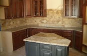 Granite countertops with travertine backsplash