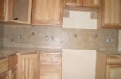 Porcelain backsplash with granite inserts
