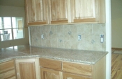 Porcelain kitchen backsplash with granite inserts