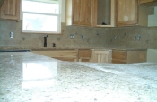 Porcelain kitchen backsplash with granite inserts