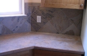 Porcelain backsplash with granite inserts and countertops