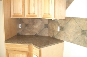 Porcelain backsplash with granite inserts and countertops