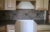 Porcelain backsplash with granite inserts and countertops