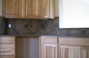 Porcelain backsplash with granite inserts and countertops