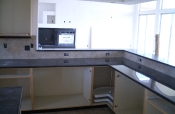 Porcelain kitchen backsplash with slate inserts and granite countertops