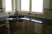 Porcelain kitchen backsplash with slate inserts and granite countertops