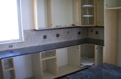 Porcelain kitchen backsplash with slate inserts and granite countertops