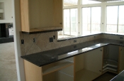 Porcelain kitchen backsplash with slate inserts and granite countertops
