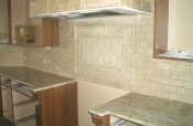 Travertine subway backsplash with granite countertops