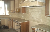Travertine subway backsplash with granite countertops