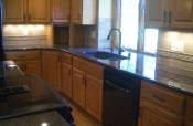 Travertine kitchen backsplash with granite countertops