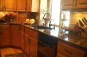 Travertine kitchen backsplash with granite countertops
