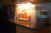 Travertine kitchen backsplash with granite countertops
