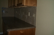 Porcelain backsplash with glass and travertine inserts