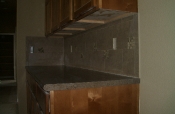Porcelain backsplash with glass and travertine inserts