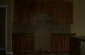 Porcelain backsplash with glass and travertine inserts