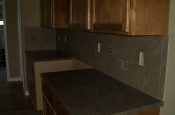 Porcelain backsplash with glass and travertine inserts