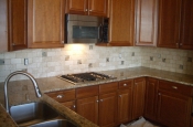 Travertine and glass kitchen tile backsplash