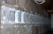 Porcelain and travertine backsplash with natural rock inserts