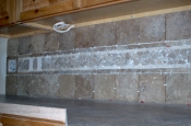 Porcelain and travertine backsplash with natural rock inserts