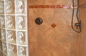 Porcelain and glass master bathroom with curved glass block walls