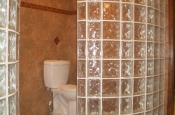 Large curved glass block walls in master bathroom