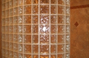 Curved glass block shower walls in master bathroom