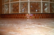 Porcelain master bathroom shower with glass mosaic wrapped curb