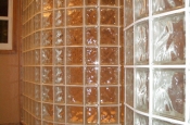 Dual curved glass block walls in master bathroom shower