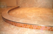 Porcelain shower floor with glass accent curb ready for glass block
