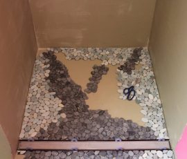 Laying out river rock mosaics