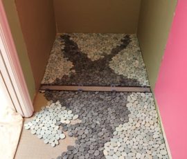Piecing together custom river rock design