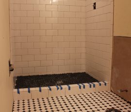 subway pattern shower with river rock
