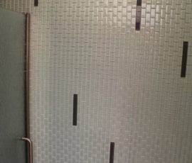 Glass mosaic accent wall in bathroom