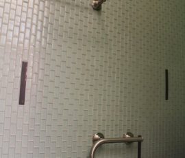 Complete glass mosaic tile wall in master bathroom